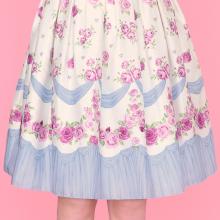 A cute white dress with a pattern of roses and blue banners by Emily Temple cute
