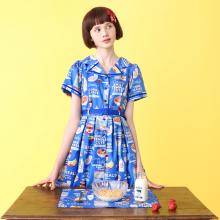Image of a blue dress with a all-over cereal print. There is also text throughout the print that says "Cereals," "Emily's Temple Cute," "Corn Flakes," "Cinnamon Flavor," and "Berry Mix."